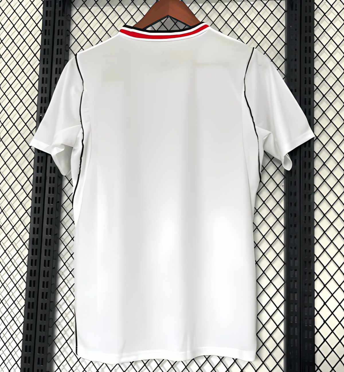 White football jersey with red and black collar, displayed on a hanger.