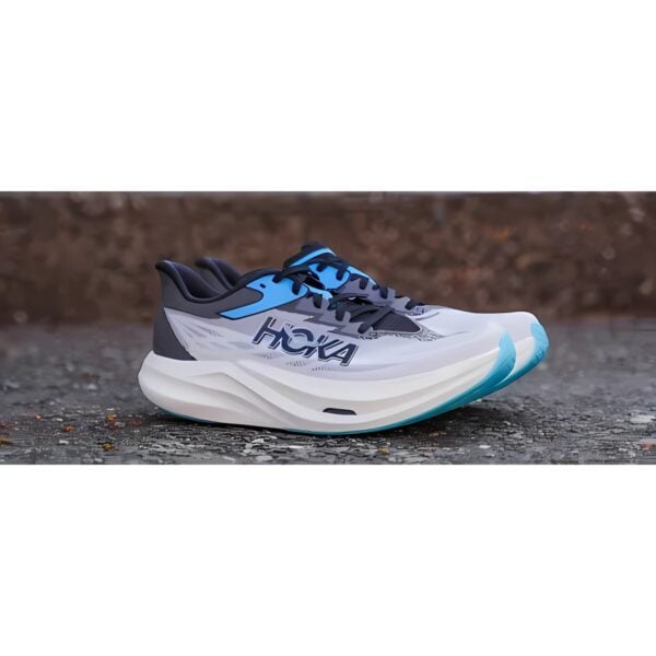 HOKA running shoe in white, blue, and black with thick sole.