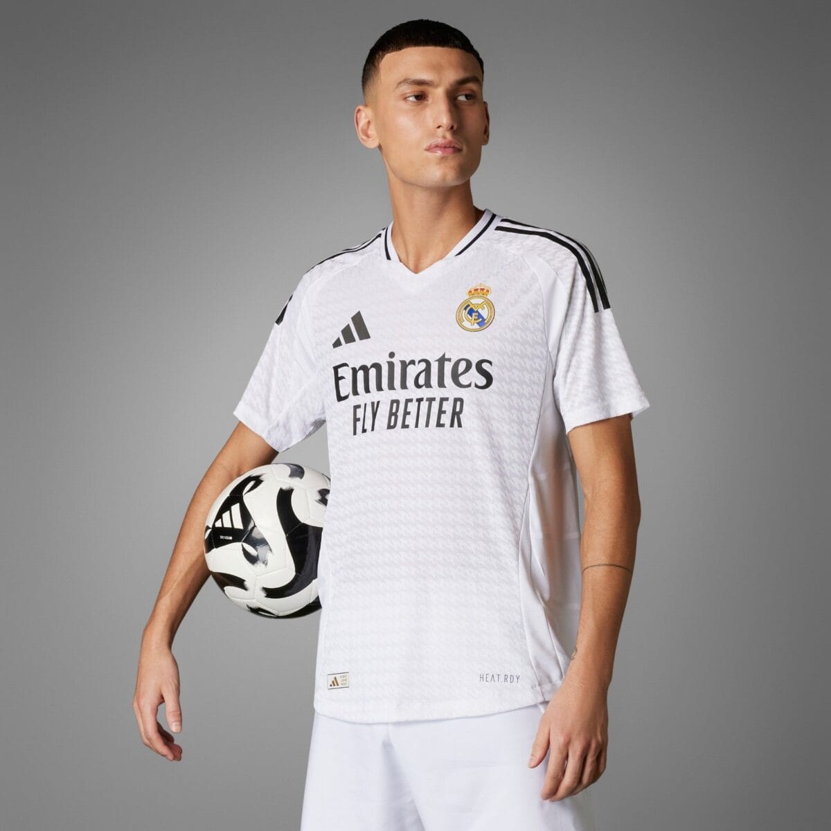 Real Madrid away kit 2023 white jersey with black stripes and logo.
