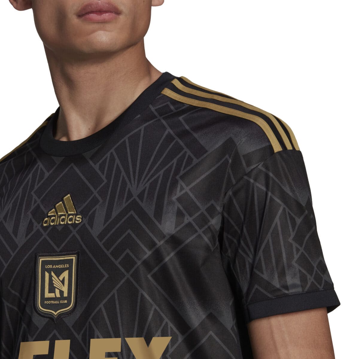 Close-up of the gold LAFC crest on the black 2022 home jersey