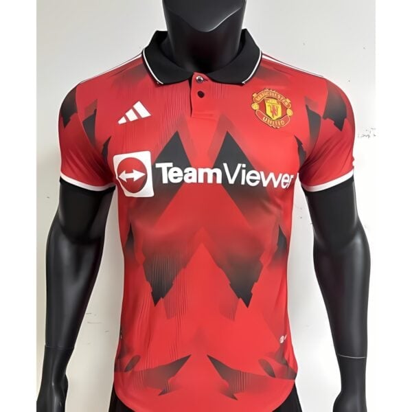 Manchester United away football jersey with red and black design, TeamViewer logo.