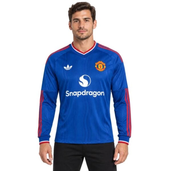 Manchester United Away Long Sleeve Jersey 202627 blue shirt front view with crest - UAE SPORT STORE Manchester United Away Long Sleeve Jersey 2026/27 blue shirt front view with crest
