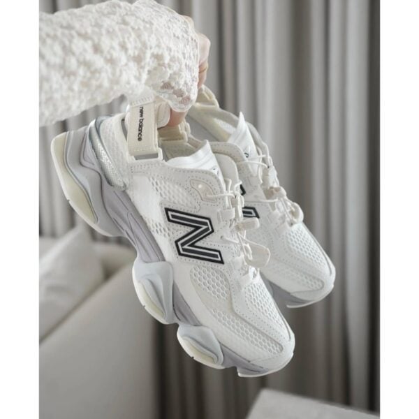 New Balance 9060 Summer Cream White Black sneakers pair held in hand - UAE SPORT STORE New Balance 9060 Summer Cream White Black sneakers pair held in hand