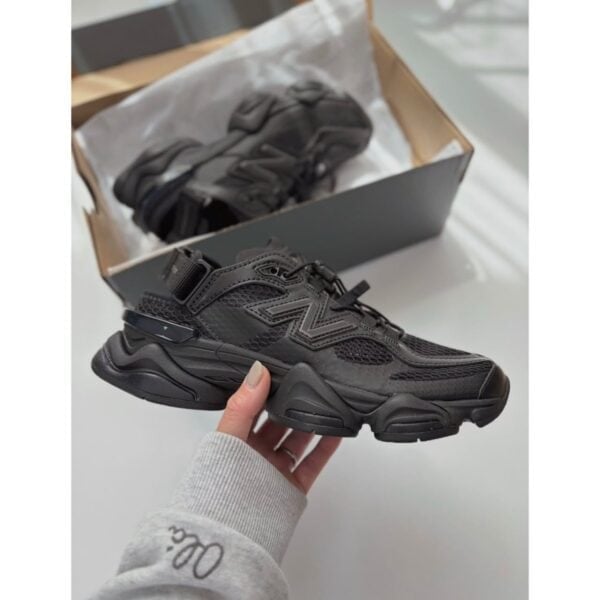 New Balance 9060 Summer Triple Black sneaker held in hand with box - UAE SPORT STORE New Balance 9060 Summer Triple Black sneaker held in hand with box