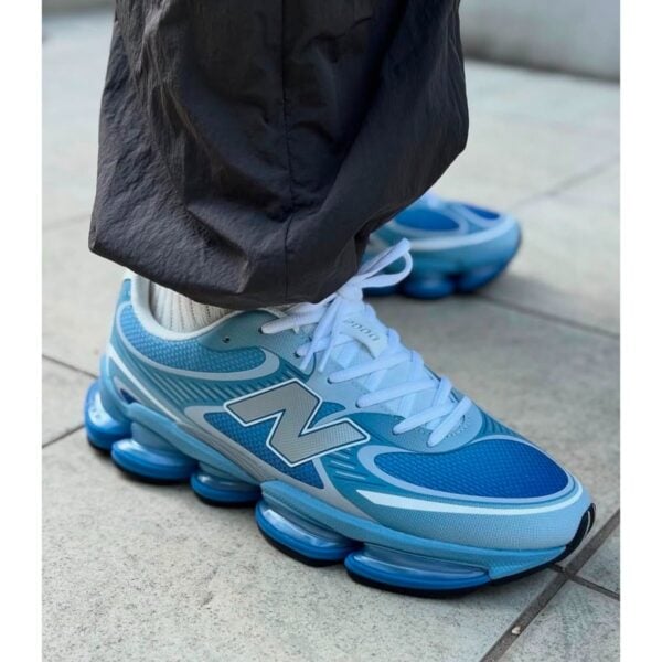 New Balance Abzorb 2000 Baby Blue sneakers worn side view with blue Abzorb sole