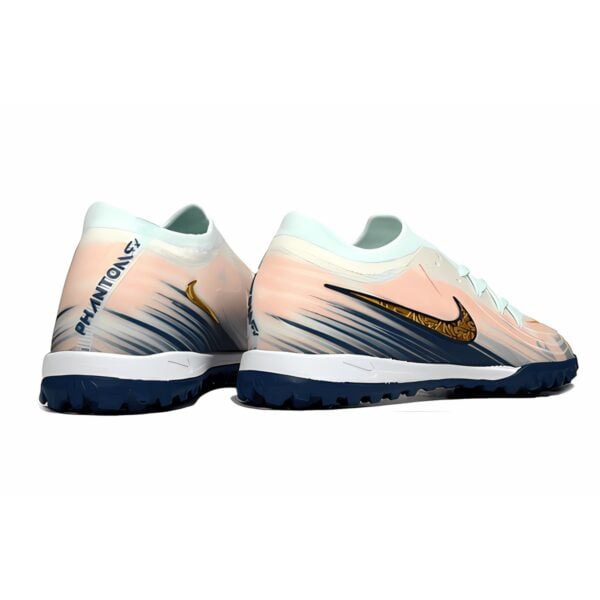 Nike Phantom Vision soccer cleats with pink, white, and navy colors.