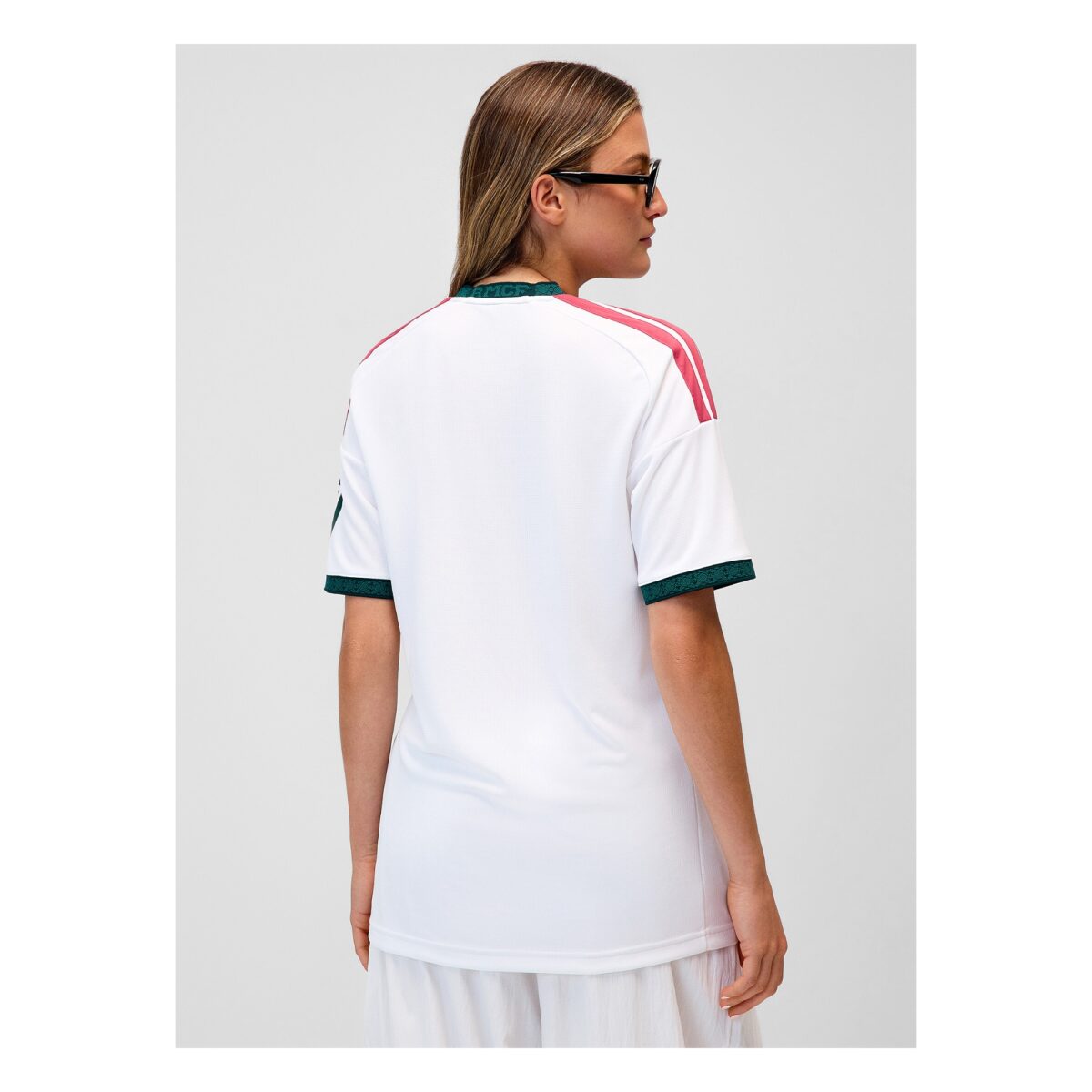 White football jersey with red and green accents, back view.