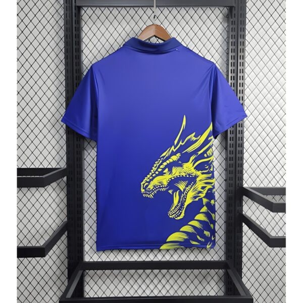 Blue sports jersey with yellow dragon graphic on back, displayed on hanger.