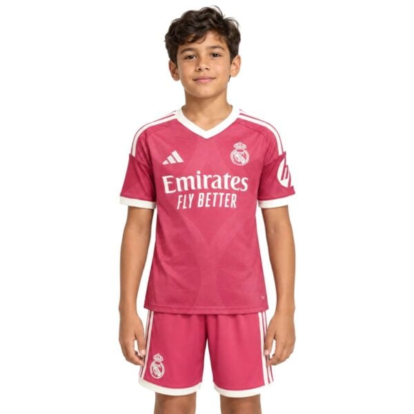 Real Madrid Third Kids Kit 202627 pink jersey and shorts front view with Emirates Fly Better - UAE SPORT STORE Real Madrid Third Kids Kit 2026/27 pink jersey and shorts front view with Emirates Fly Better