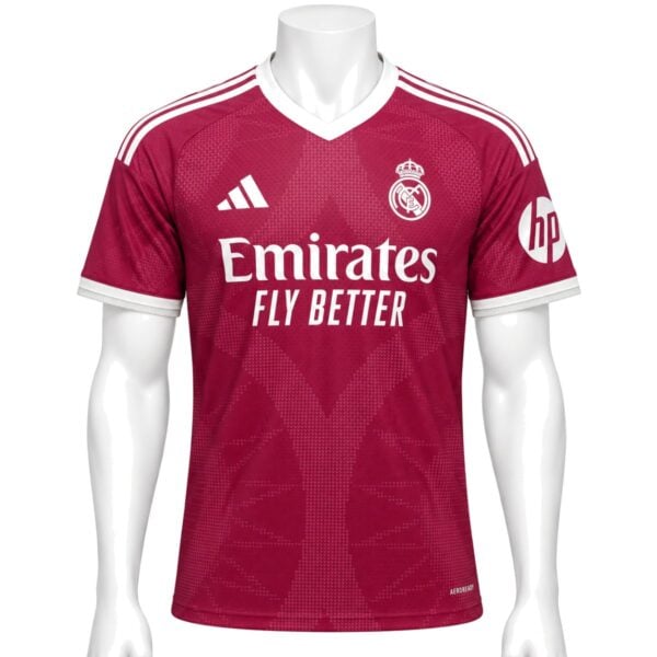 Real Madrid Third Player Version Jersey 202627 front raspberry red shirt with white V-neck and Emirates Fly Better - UAE SPORT STORE Real Madrid Third Player Version Jersey 2026/27 front – raspberry red shirt with white V-neck and Emirates Fly Better