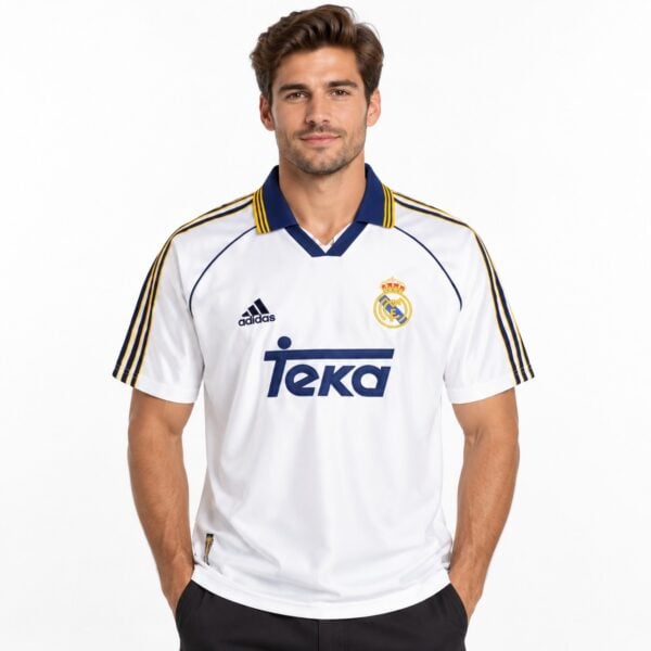 Real Madrid away kit jersey with white, blue, and gold colors, season not specified.