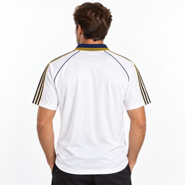 White football jersey with black and gold stripes on shoulders, back view.