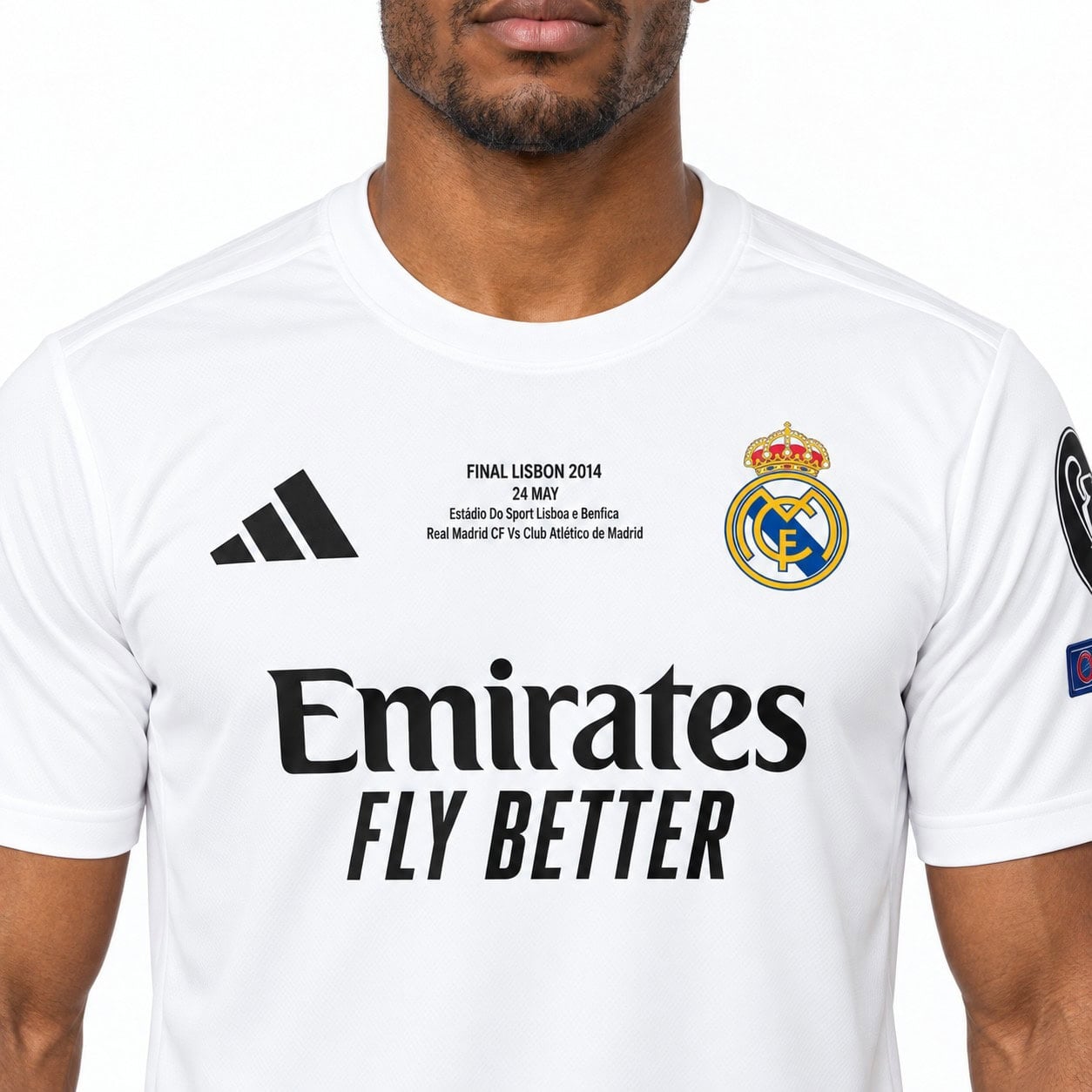 rm-fc-white-shirt-5 - UAE SPORT STORE Close-up of the white Real Madrid shirt showing the crest, small FINAL LISBON 2014 inscription and black Emirates lettering.