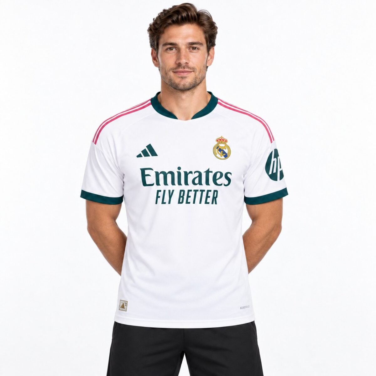 Real Madrid home football jersey with white, pink, and dark green colors.
