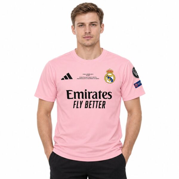 Real Madrid away kit 2023 pink jersey with club crest and sponsor logo.