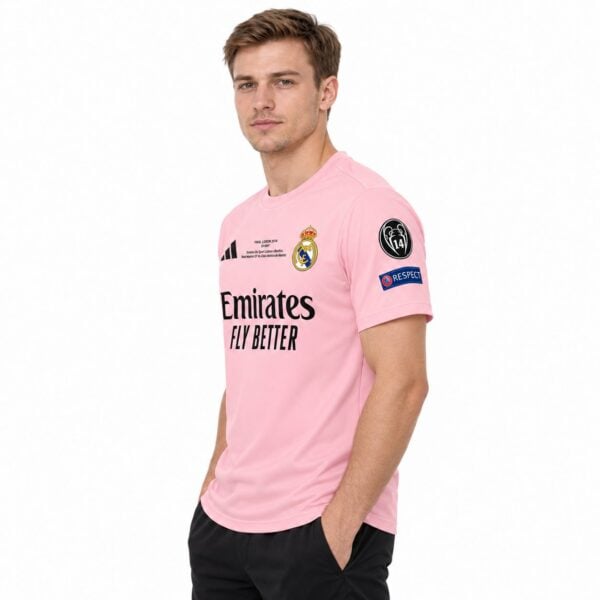 Real Madrid pink away kit jersey with club badge and sponsor logo.