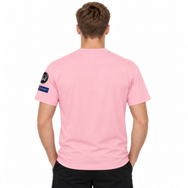 Pink football jersey with UEFA Champions League and UEFA Respect patches on sleeves.