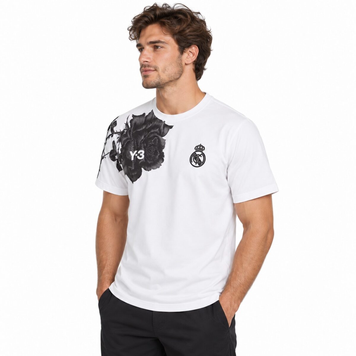 Real Madrid white T-shirt with black floral design on shoulder and club logo.