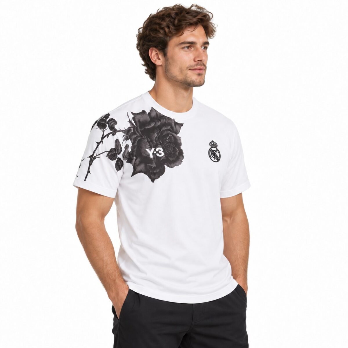 White Real Madrid T-shirt with black floral design and club crest.
