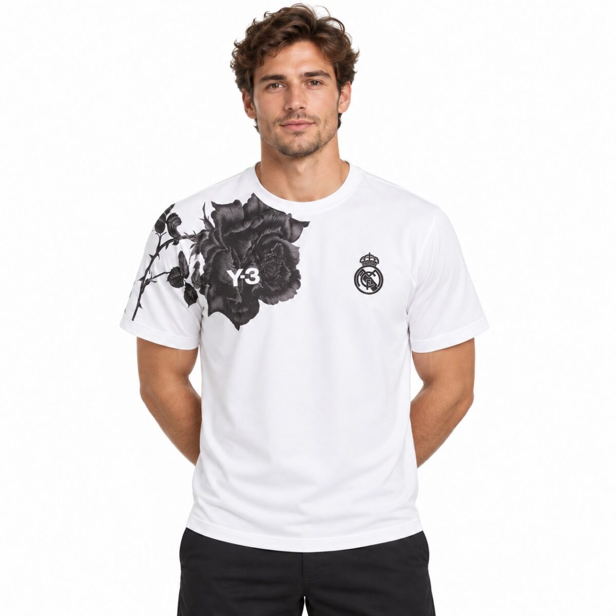 Real Madrid white home jersey with black floral design and club crest.