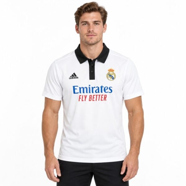 Real Madrid home football jersey with white body, black collar, and club crest.