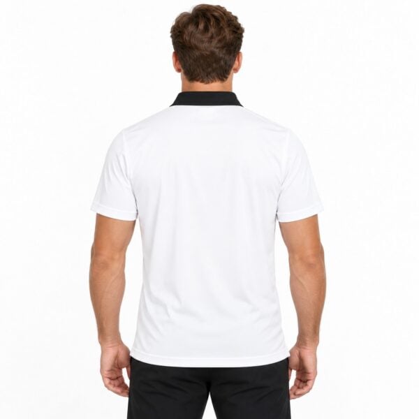Back view of a man wearing a white sports polo shirt with black collar.