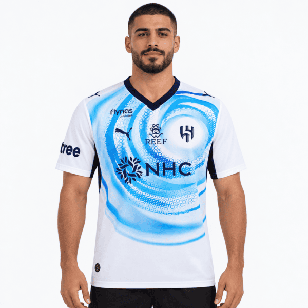 Football player in white and blue Al Hilal away jersey 2026/27.