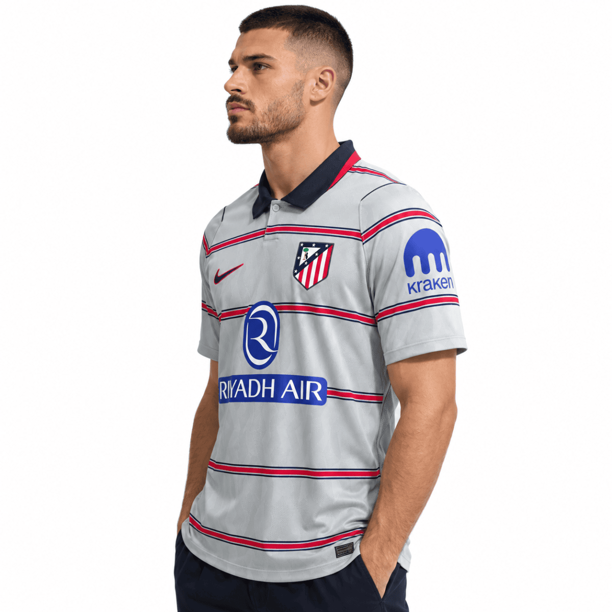 Atletico Madrid third jersey 2026/27 with grey, red, and blue stripes and club crest.