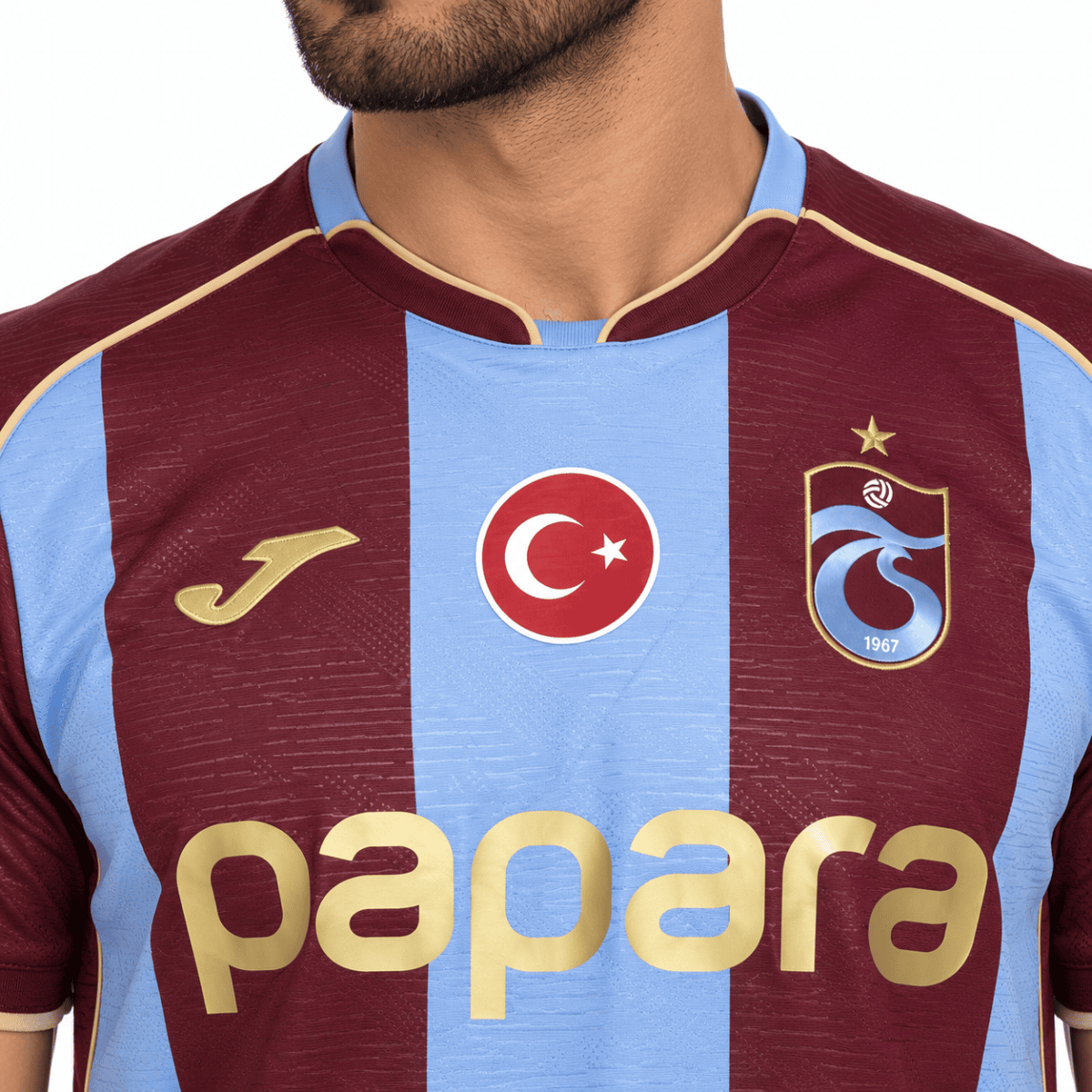 Trabzonspor home football jersey with blue and claret stripes, club crest, and sponsor logo.