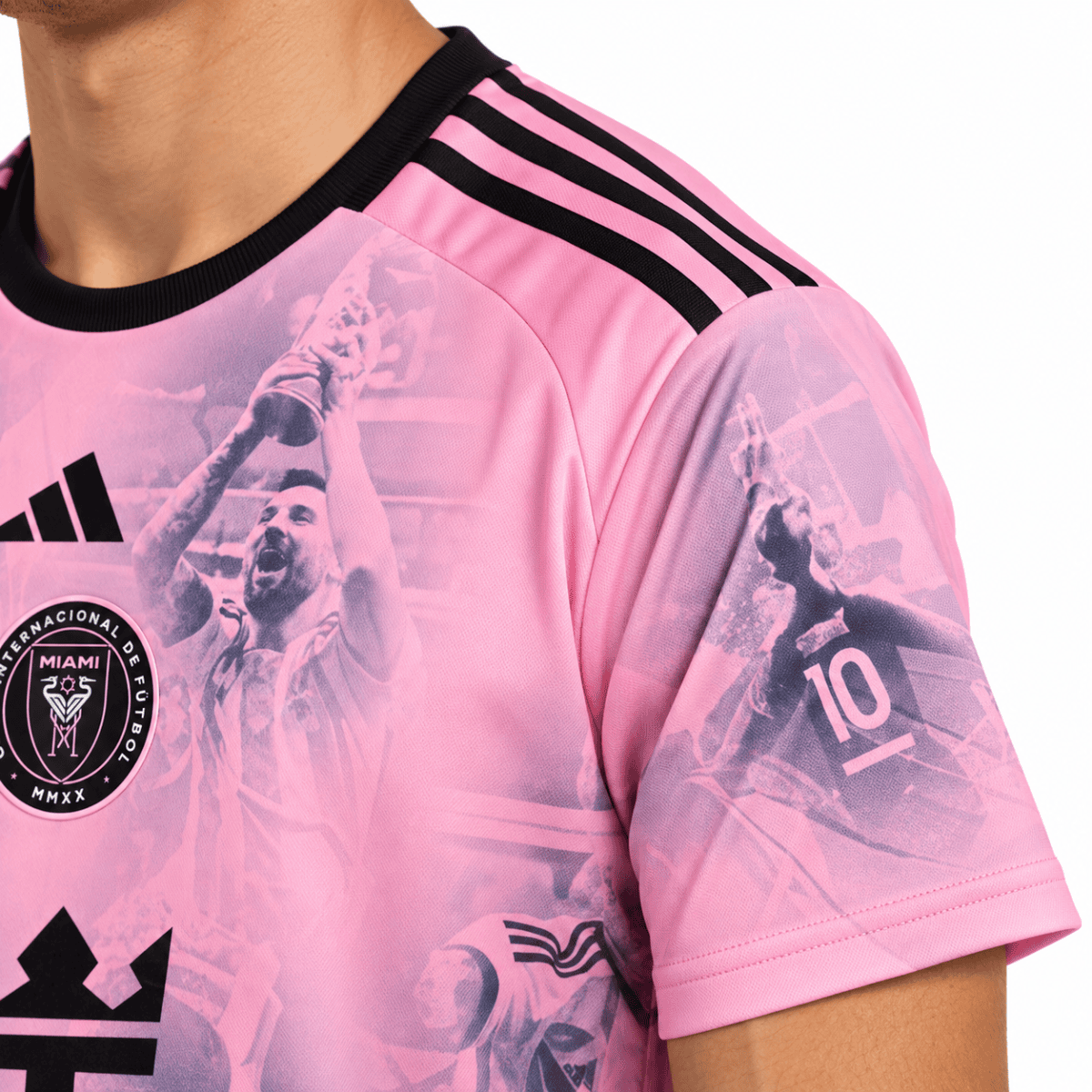 Shoulder and sleeve of a pink Inter Miami collage shirt with black shoulder stripes.