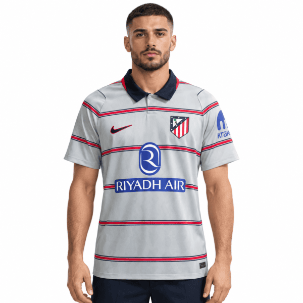 Atletico Madrid third jersey 2026/27 with grey, red, and navy colors and club crest.
