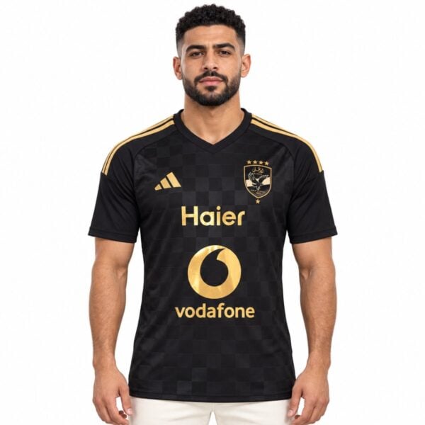 Al Ahly away jersey 2026 2027 black front view with gold crest gold shoulder stripes and checkerboard texture - UAE SPORT STORE Al Ahly away jersey 2026 2027 black front view with gold crest gold shoulder stripes and checkerboard texture