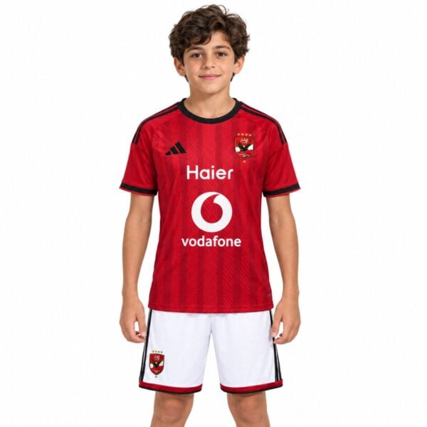 Al Ahly home kids kit 2026 2027 red jersey with four star crest and white shorts front view - UAE SPORT STORE Al Ahly home kids kit 2026 2027 red jersey with four star crest and white shorts front view