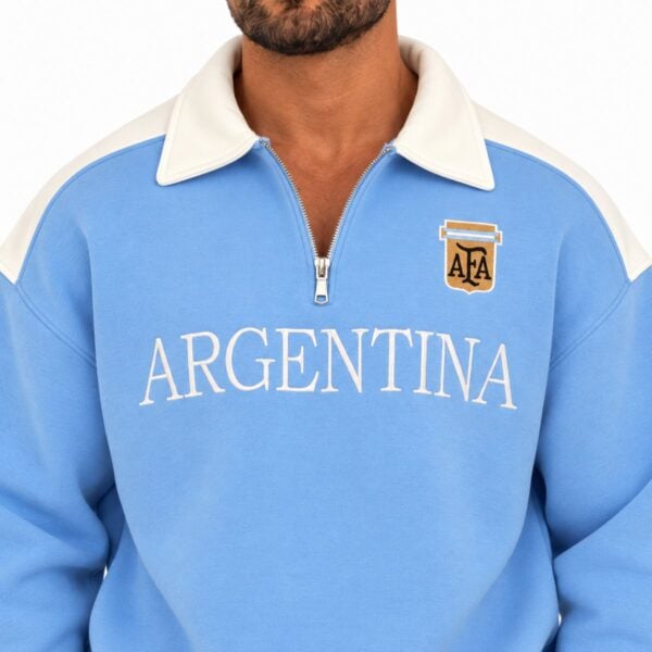 Argentina sweatshirt close-up showing cream spread collar metal quarter zip and embroidered AFA crest