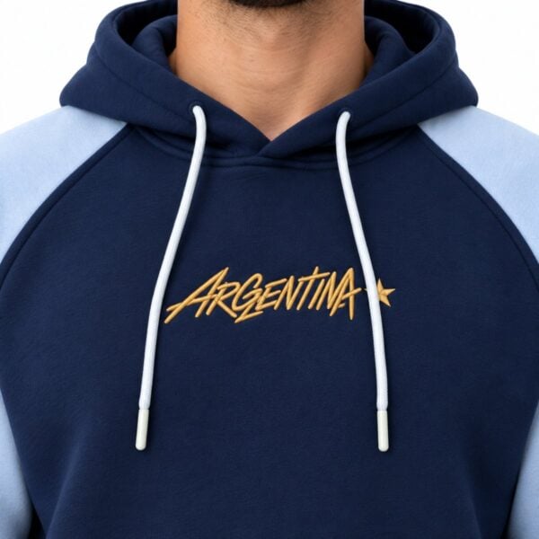Argentina hoodie close-up of gold embroidered ARGENTINA script with star on navy fleece
