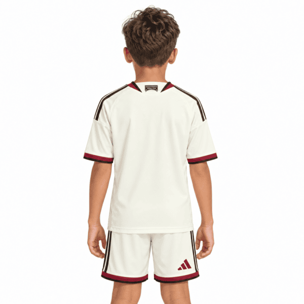 Kids Manchester United third kit 2026/27 in cream with red and black accents.