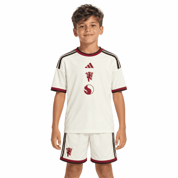 Kids Manchester United third kit 2026/27 in white with red and black accents.