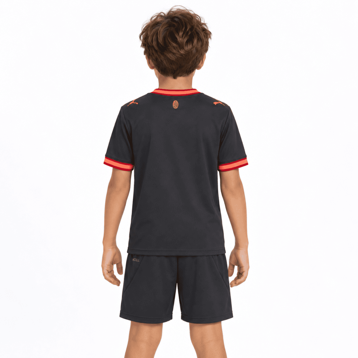 Child wearing AC Milan third kit football jersey and shorts, back view.