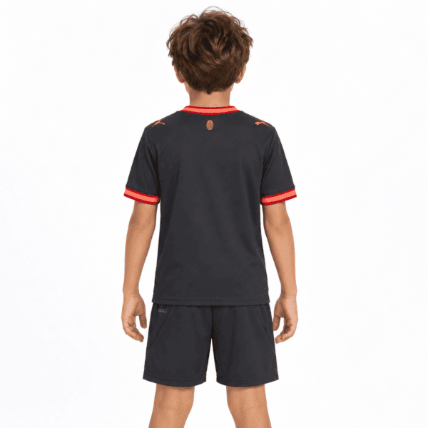 Child wearing AC Milan third kit football jersey and shorts, back view.