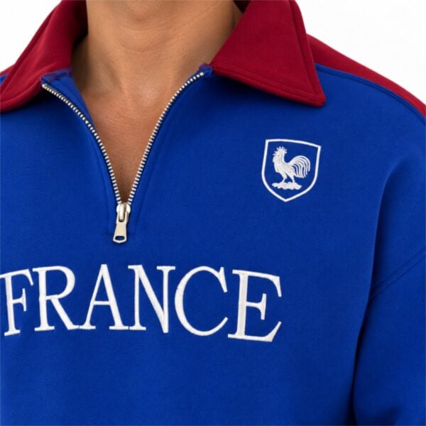 France sweatshirt close-up of burgundy collar gold quarter zip embroidered rooster shield and FRANCE lettering
