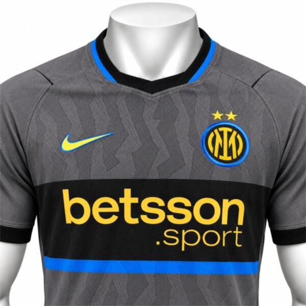 Inter Milan third player version jersey close-up of the IM crest two gold stars and black V-neck with blue trim