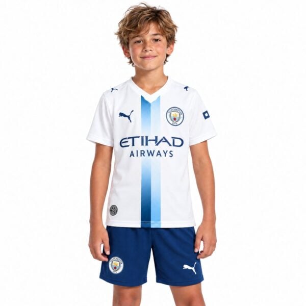 Manchester City third kids kit 2026 2027 front view white jersey with blue centre stripe and navy shorts - UAE SPORT STORE Manchester City third kids kit 2026 2027 front view white jersey with blue centre stripe and navy shorts