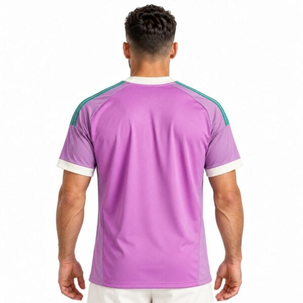 Rear of the lilac Manchester United shirt with green shoulder stripes and cream sleeve edges.