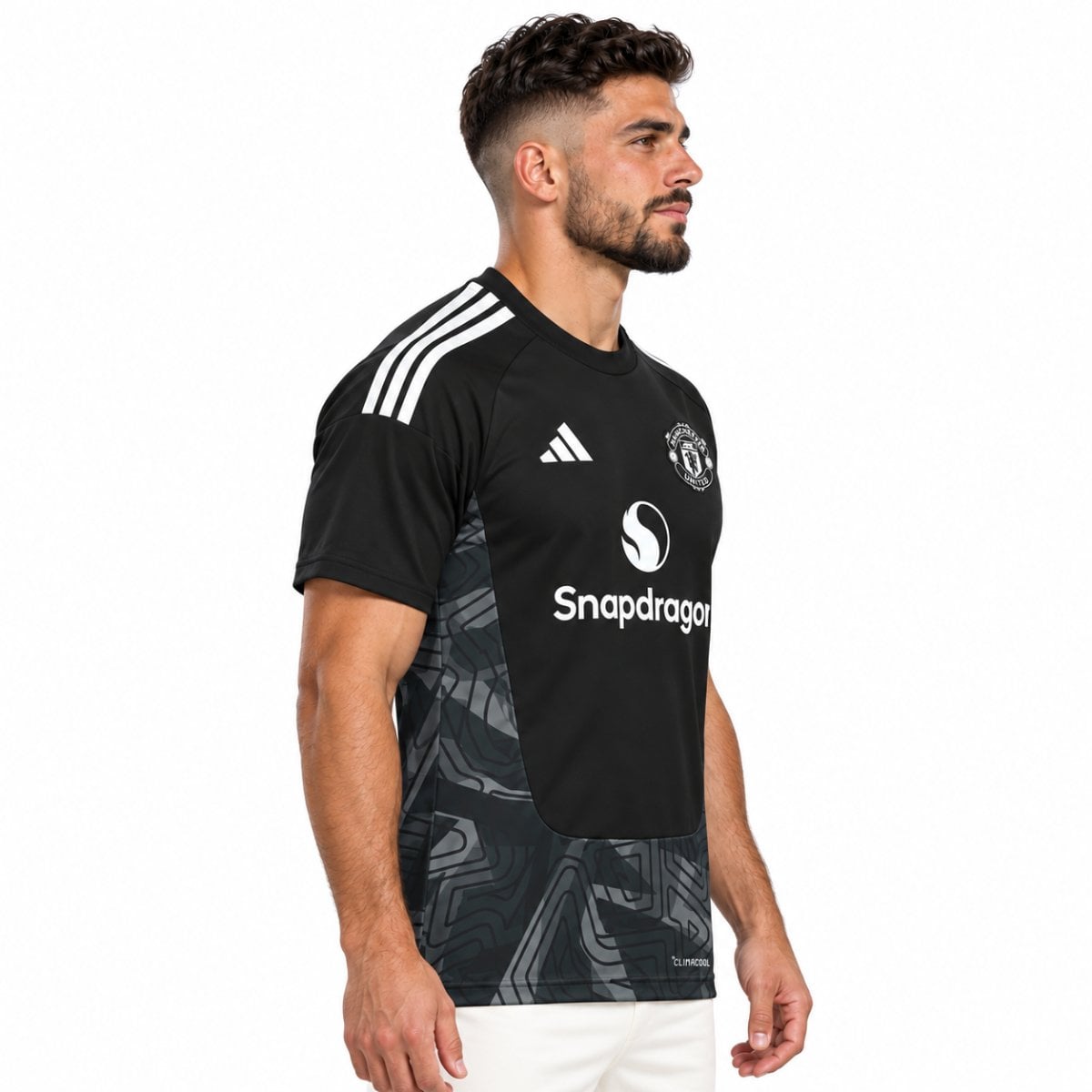 Manchester United home goalkeeper jersey angled view black bib panel over grey maze print - UAE SPORT STORE Manchester United home goalkeeper jersey angled view black bib panel over grey maze print