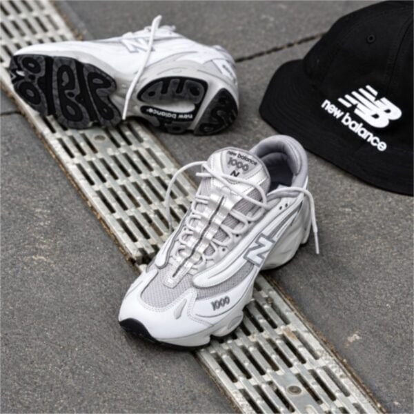 New Balance 1000 grey and white pair with NB cap showing the upper and outsole - UAE SPORT STORE New Balance 1000 grey and white pair with NB cap showing the upper and outsole