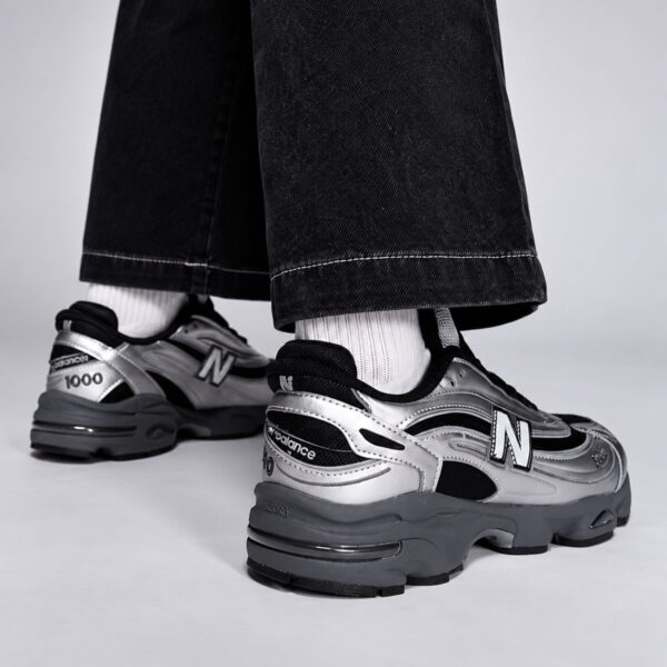 New Balance 1000 silver and black pair back view with 1000 heel branding