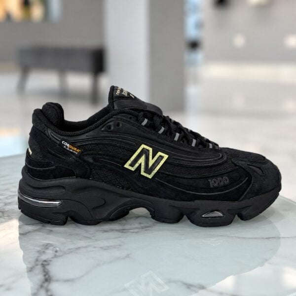 New Balance 1000 triple black CORDURA sneaker side profile with glow green N logo - UAE SPORT STORE New Balance 1000 triple black CORDURA sneaker side profile with glow green N logo