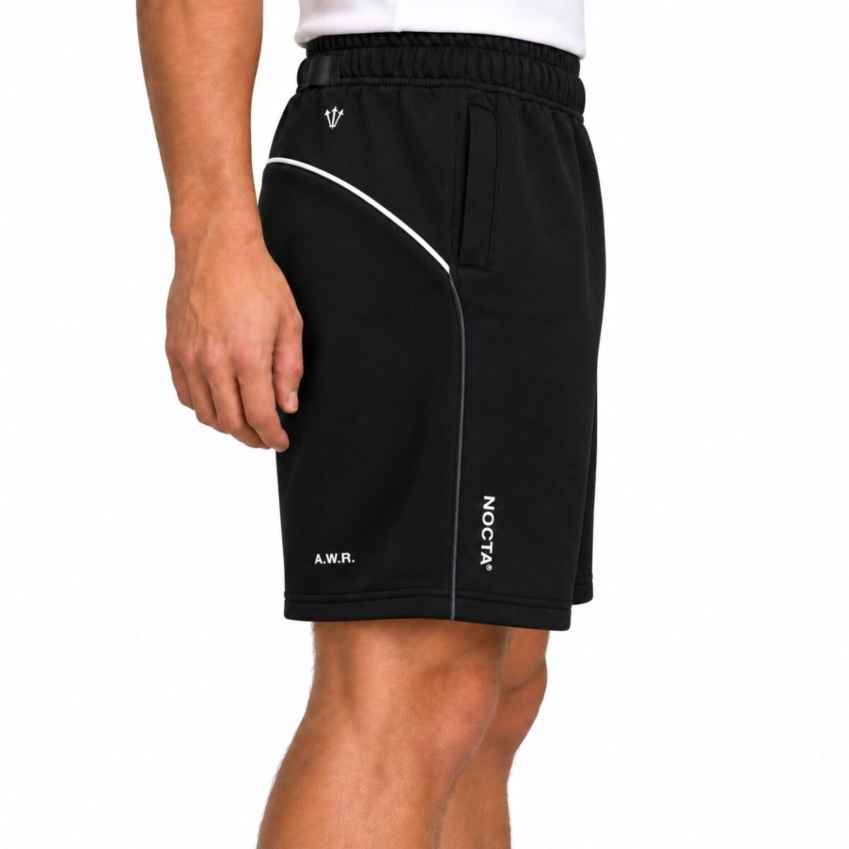 Black sports shorts with white piping and logo, A.W.R. and NOCTA branding.