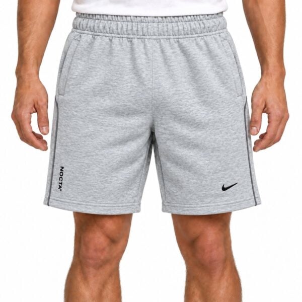 nike-nocta-shorts-gray-1 - UAE SPORT STORE Gray Nike sports shorts with black logo and side stripes for men.
