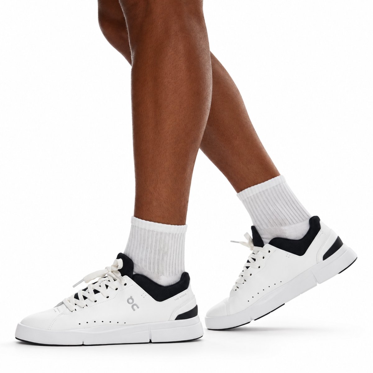 On The Roger Advantage white and black sneakers side view walking